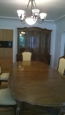 Apt # 1 Dining area featuring ornamental molding, a chandelier, and arched walkways