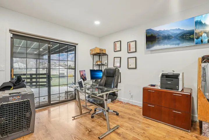 Home office featuring light wood-style floors and recessed lighting
