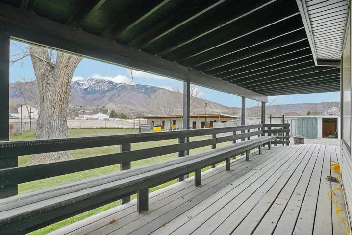 Deck with a mountain view and a fenced backyard