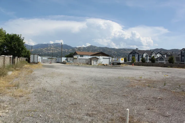View of front of home featuring a mountain view, a residential view, and an outbuilding