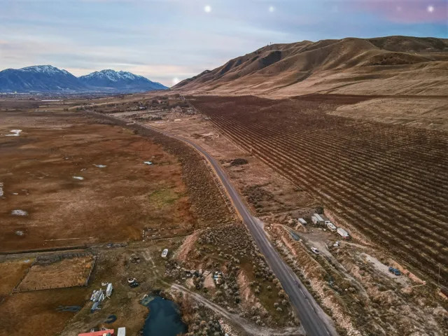 Aerial overview of property's location featuring rural landscape and a mountainous background