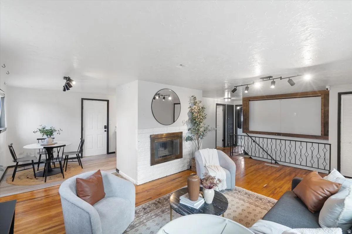 Living room includes wiring for a projector and has an installed projector screen