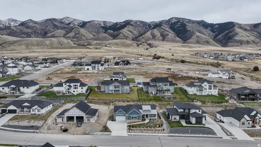 View of property location featuring nearby suburban area and a mountain backdrop