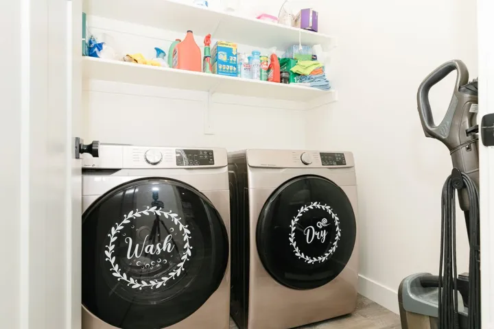 Washroom featuring washing machine and dryer and wood finished floors