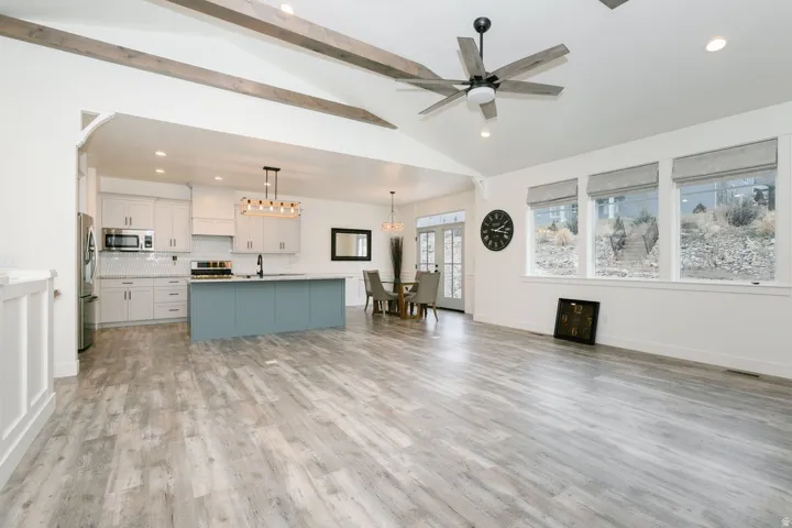 Living room with recessed lighting, light wood-style floors, and a ceiling fan