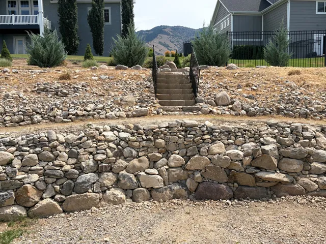 Stone retaining wall with a natural rock facade