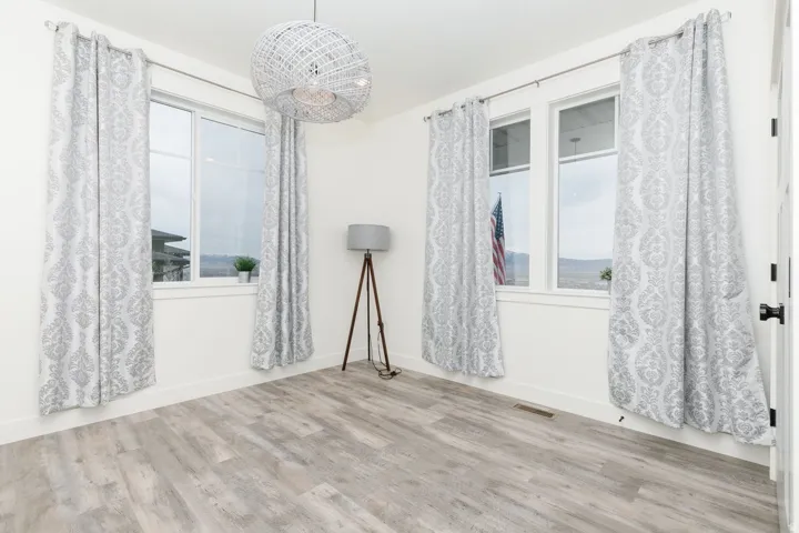Flex room featuring light wood finished floors and baseboards