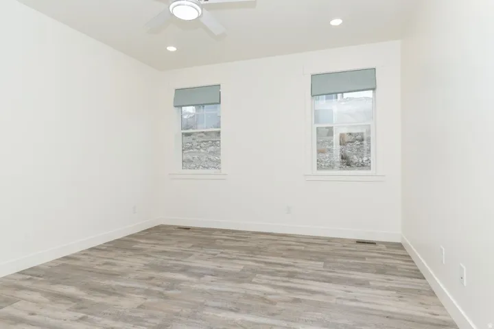 Bedroom with plenty of natural light, light wood-style flooring, recessed lighting, and a ceiling fan