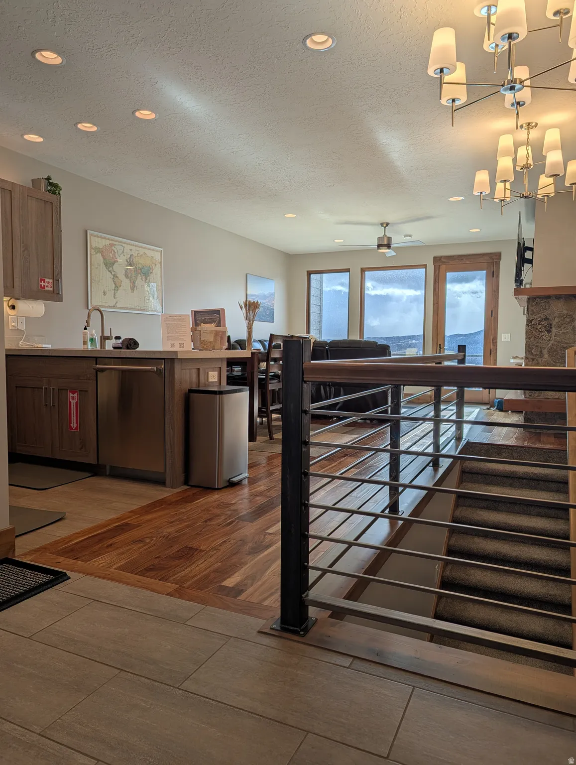 Kitchen with a chandelier, dishwasher, a textured ceiling, recessed lighting, and a peninsula