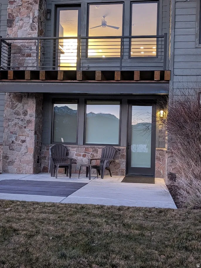 Entrance to property featuring stone siding