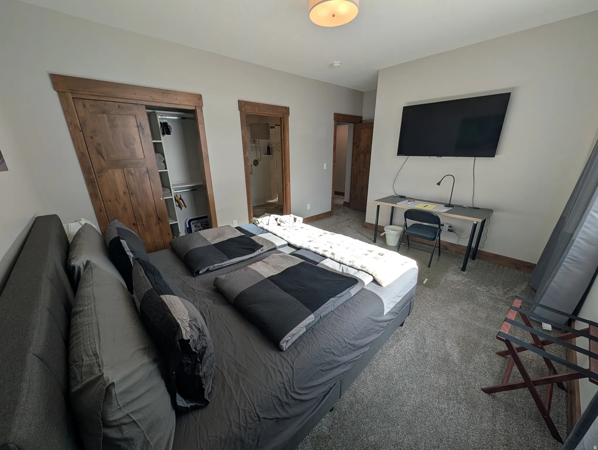 Bedroom featuring connected bathroom and carpet
