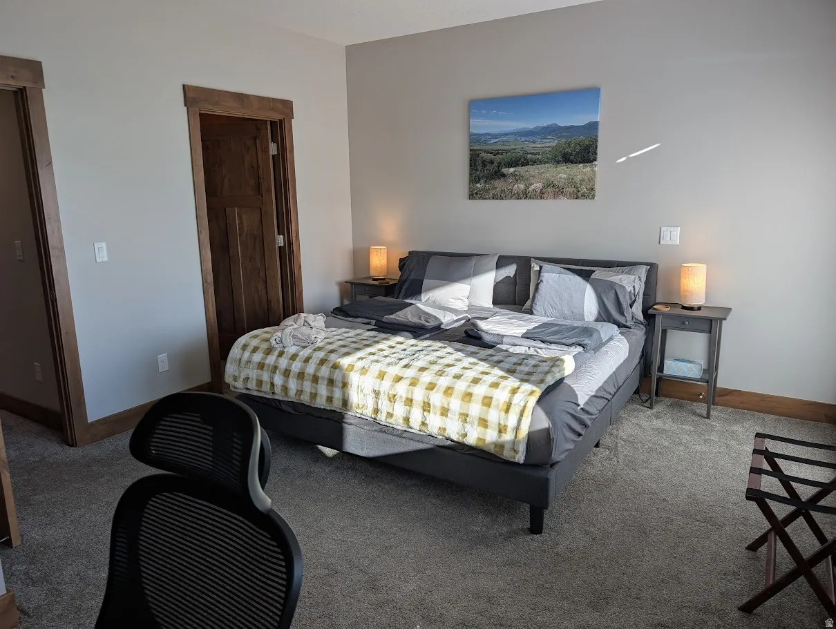 Carpeted bedroom featuring baseboards