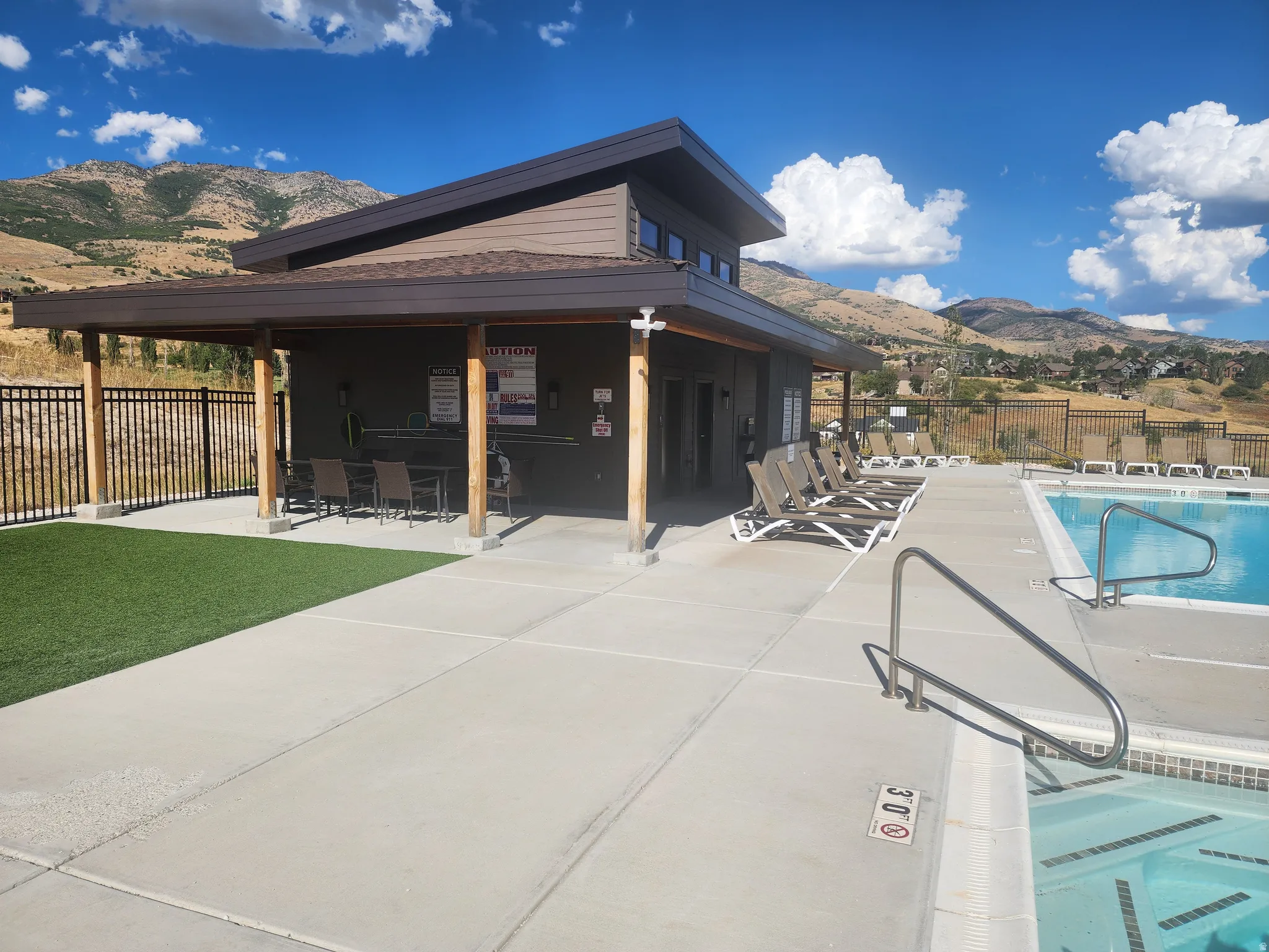 Community pool featuring a mountain view and a patio area