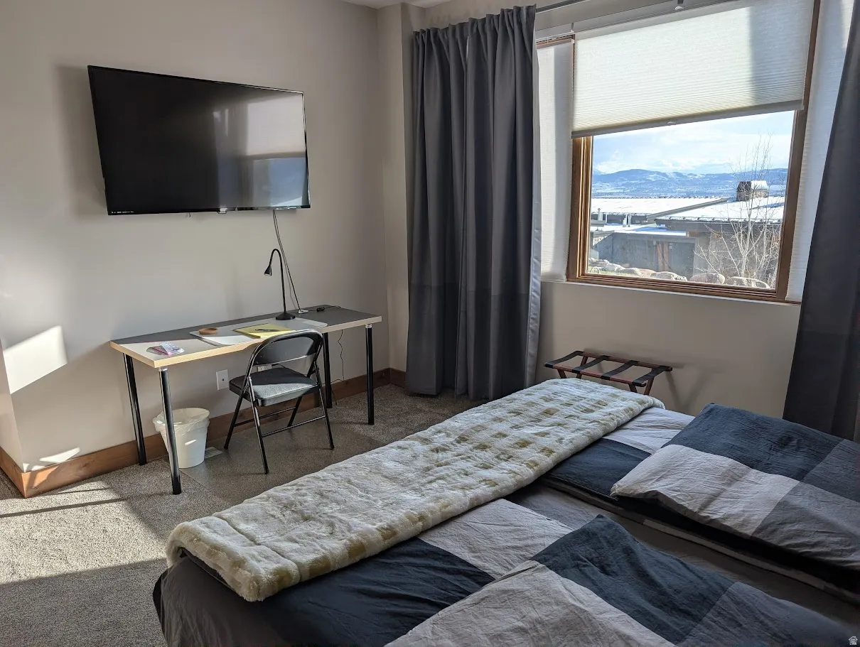 Bedroom featuring carpet flooring and baseboards