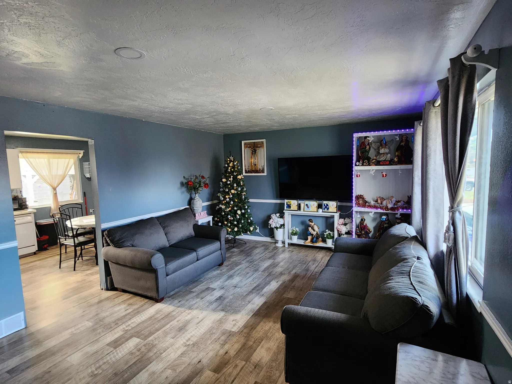 Living area with a textured ceiling and wood finished floors