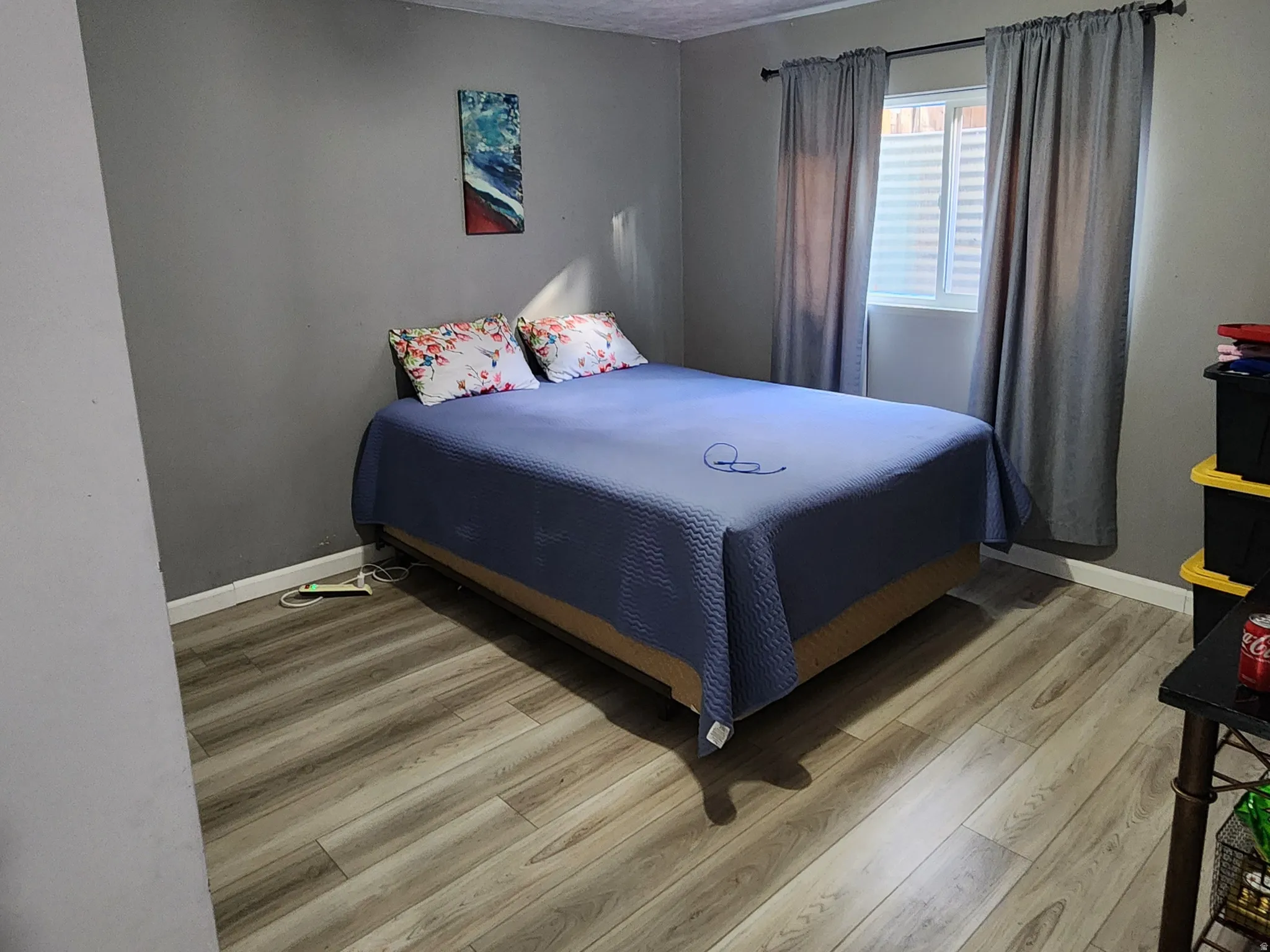 Bedroom with light wood-type flooring and a textured ceiling