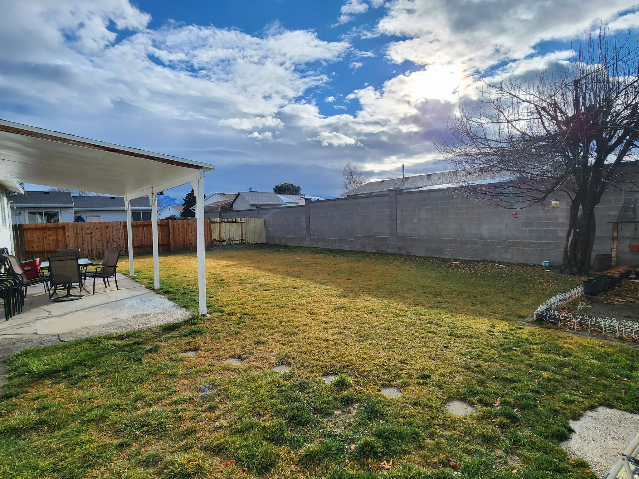 Fenced backyard with a patio area