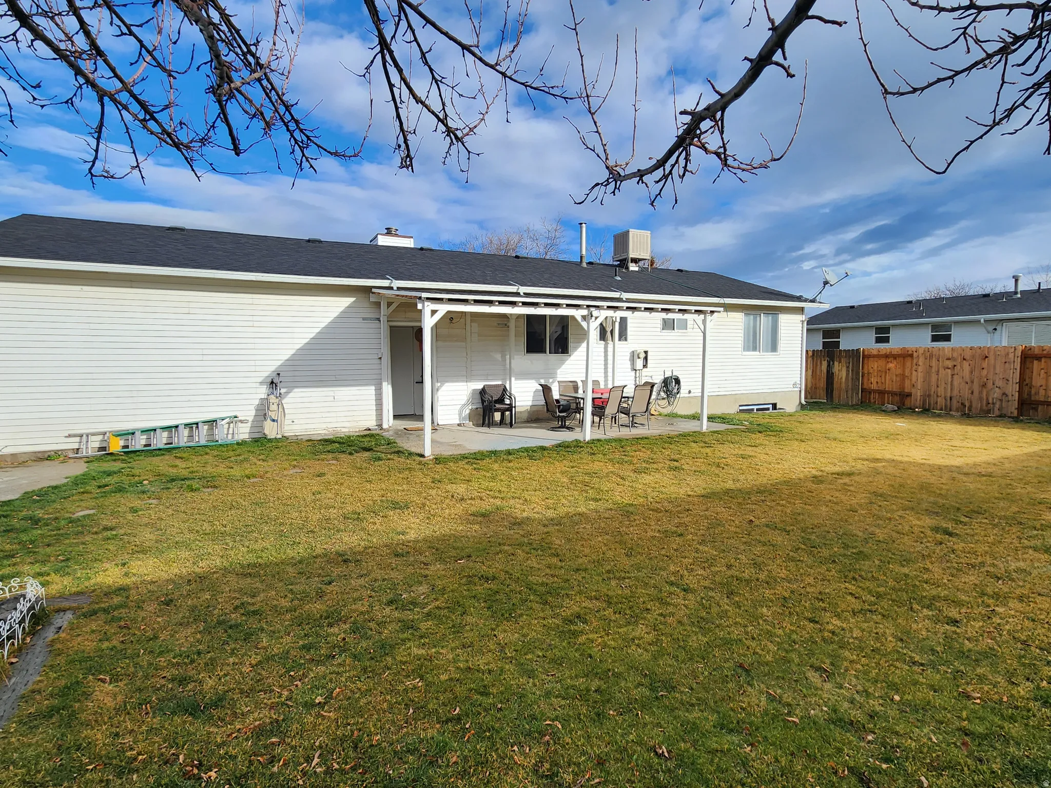 Rear view of house featuring a patio area and a chimney