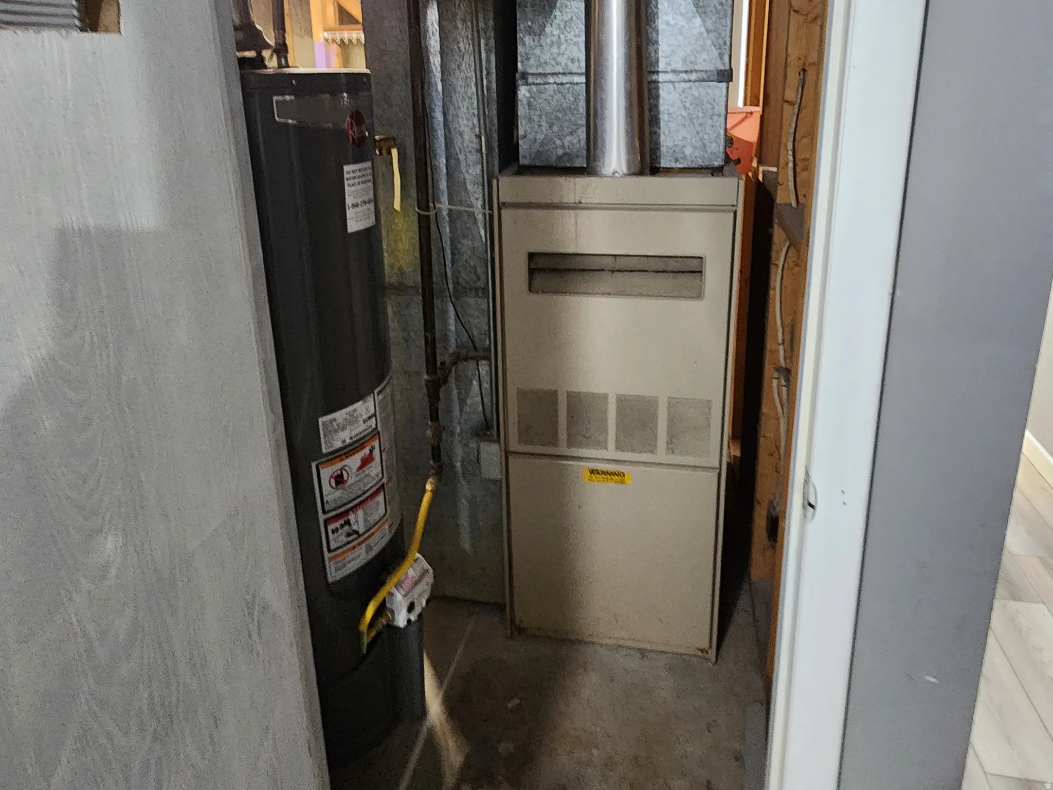 Utilities featuring water heater and heating unit