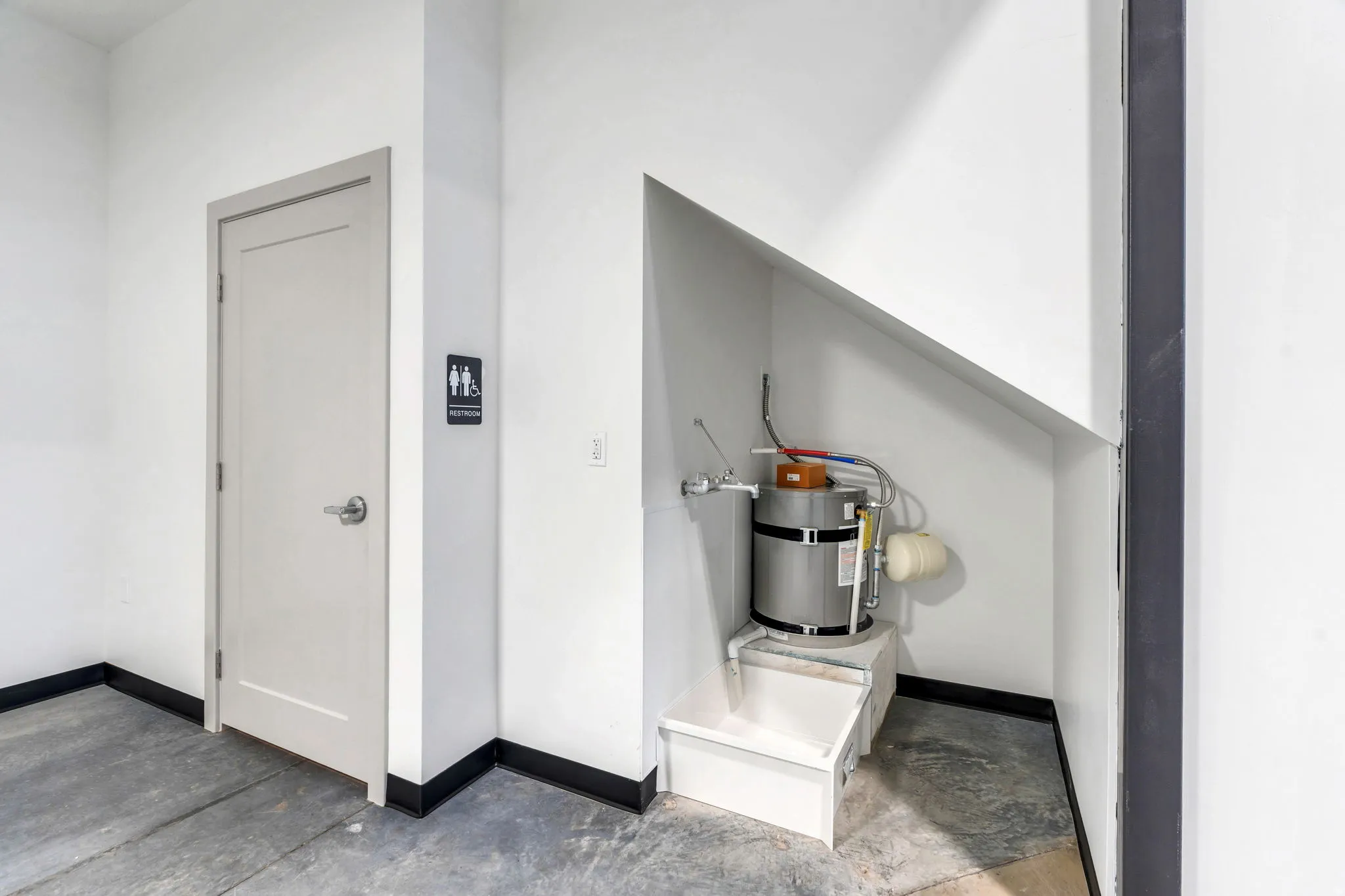 Detailed view of concrete floors and strapped water heater