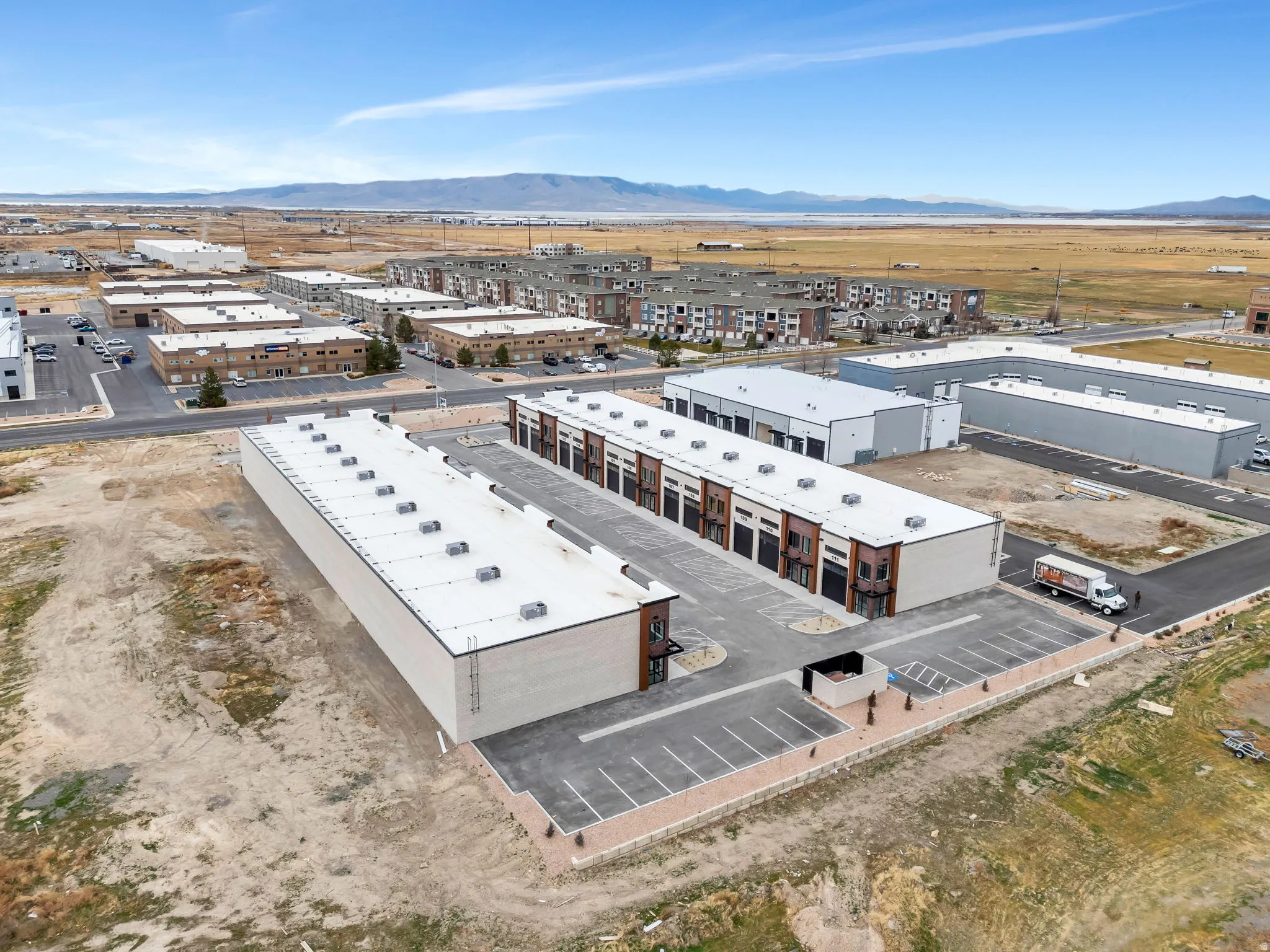 Bird's eye view of industrial structures and a mountain backdrop