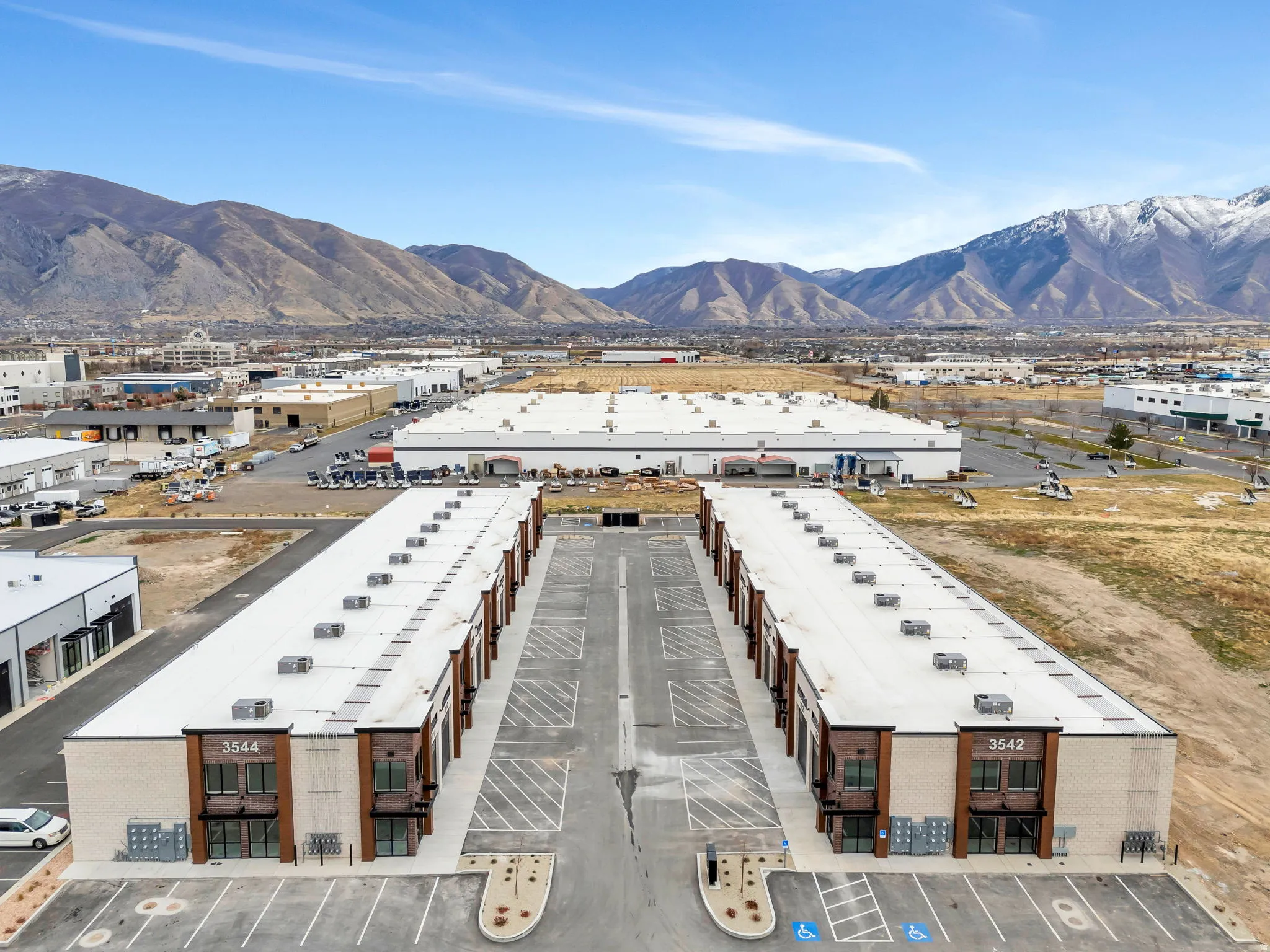 Aerial view of an industrial area and a mountainous background