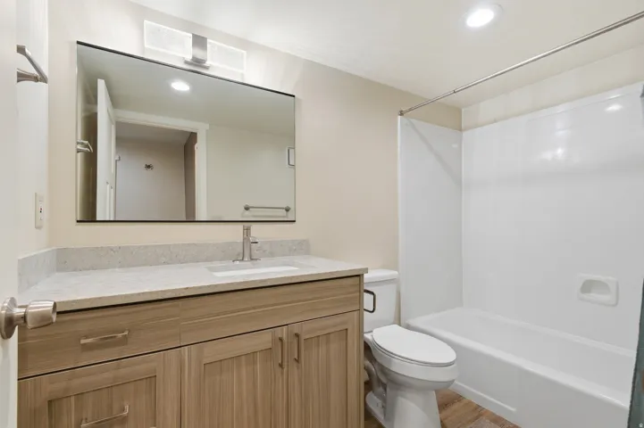 Bathroom featuring vanity, recessed lighting, and shower / washtub combination