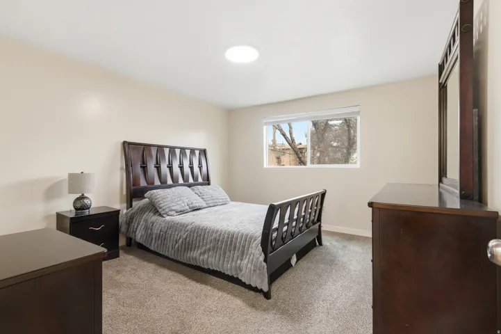 Bedroom featuring light carpet
