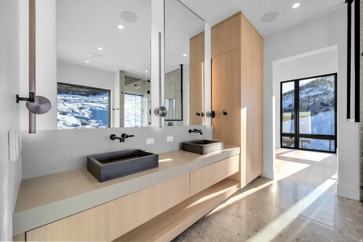 Full bathroom featuring a marble finish shower, double vanity, and recessed lighting