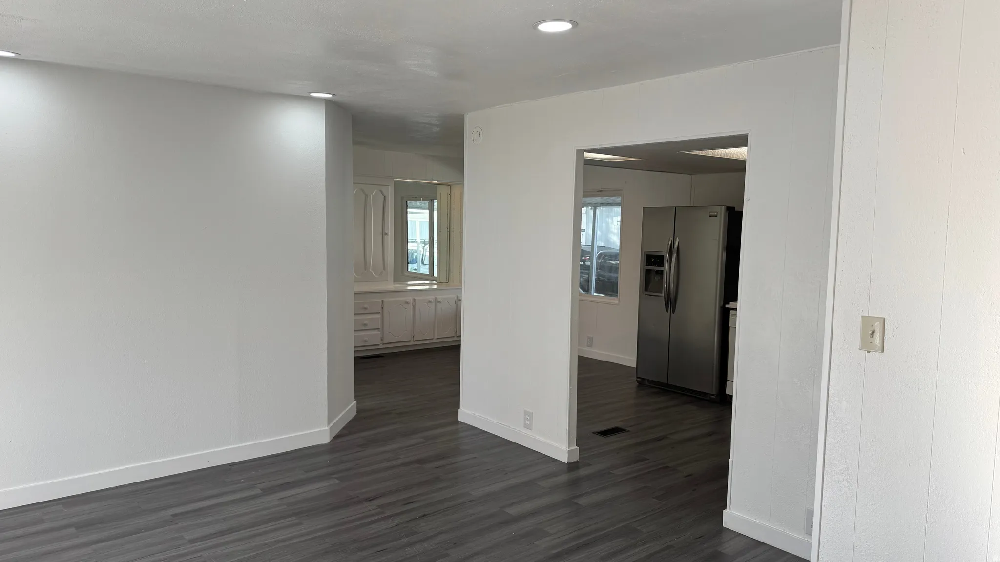 Spare room featuring dark wood finished floors and recessed lighting