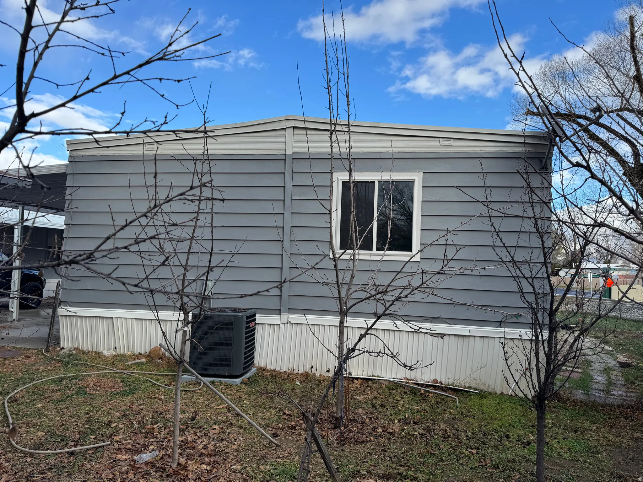 View of property exterior with a central AC unit