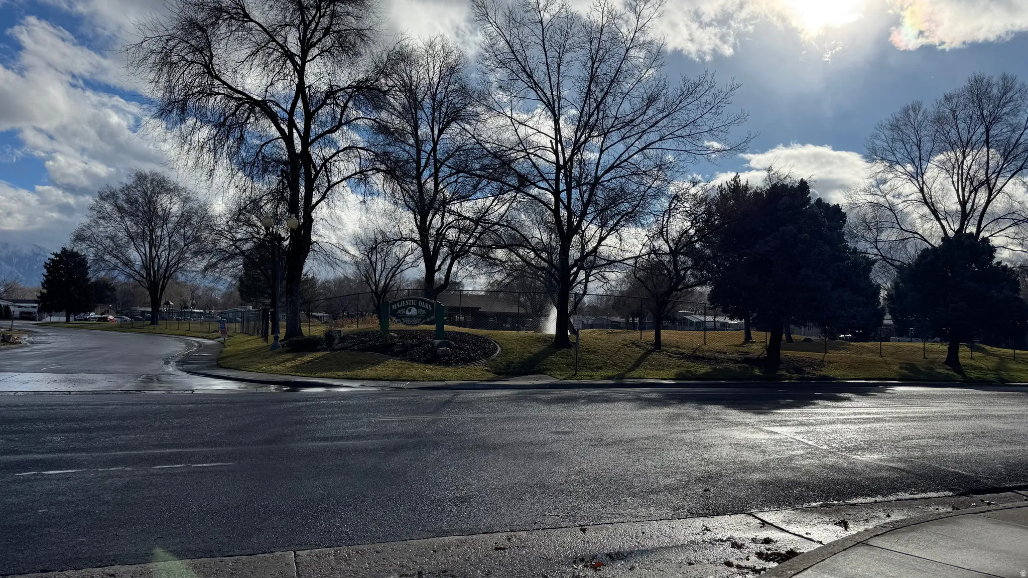 View of asphalt road with curbs