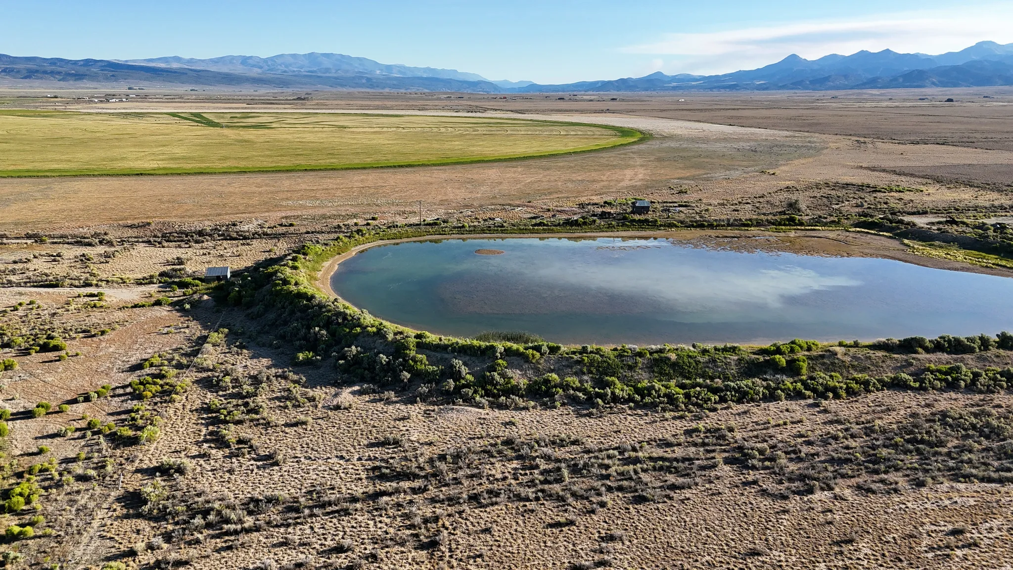 Overview of rural landscape featuring a mountainous background and a desert landscape