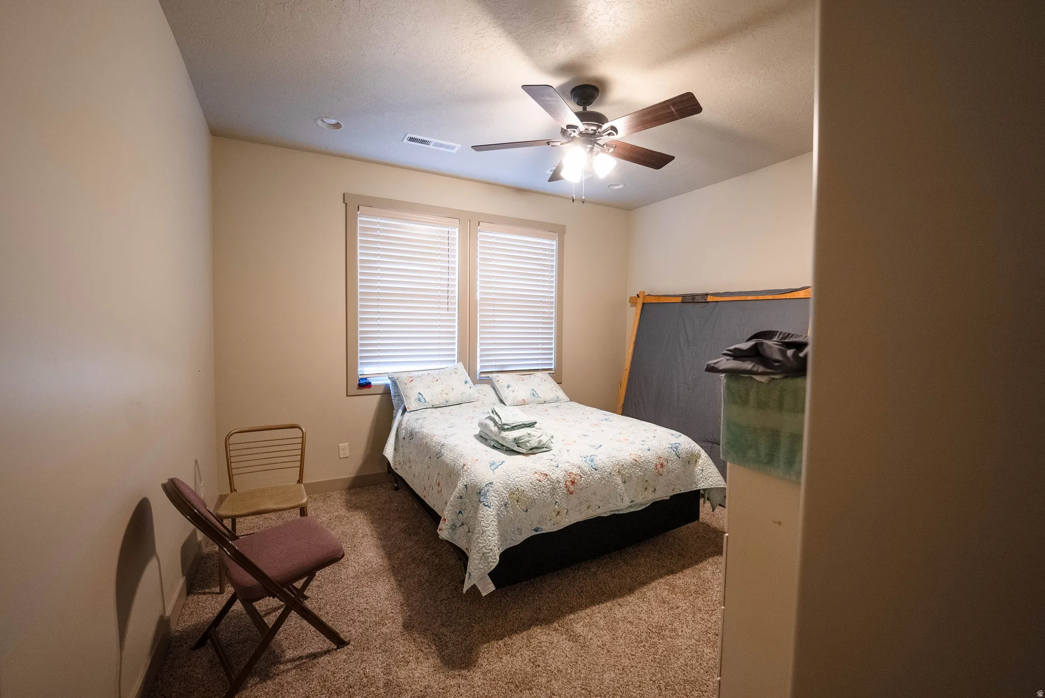 Bedroom with carpet and ceiling fan
