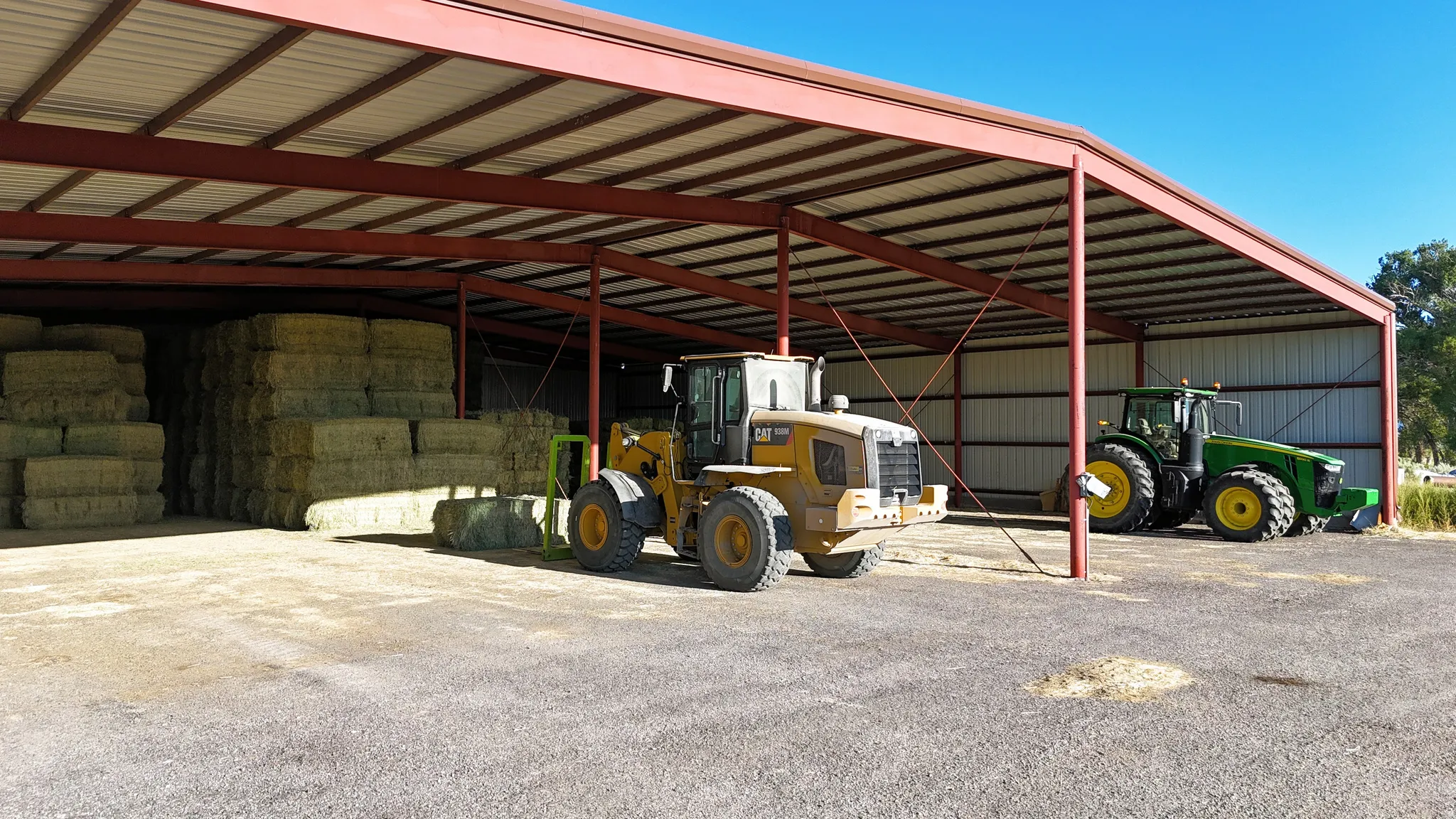 View of parking / parking lot with a pole building and a carport