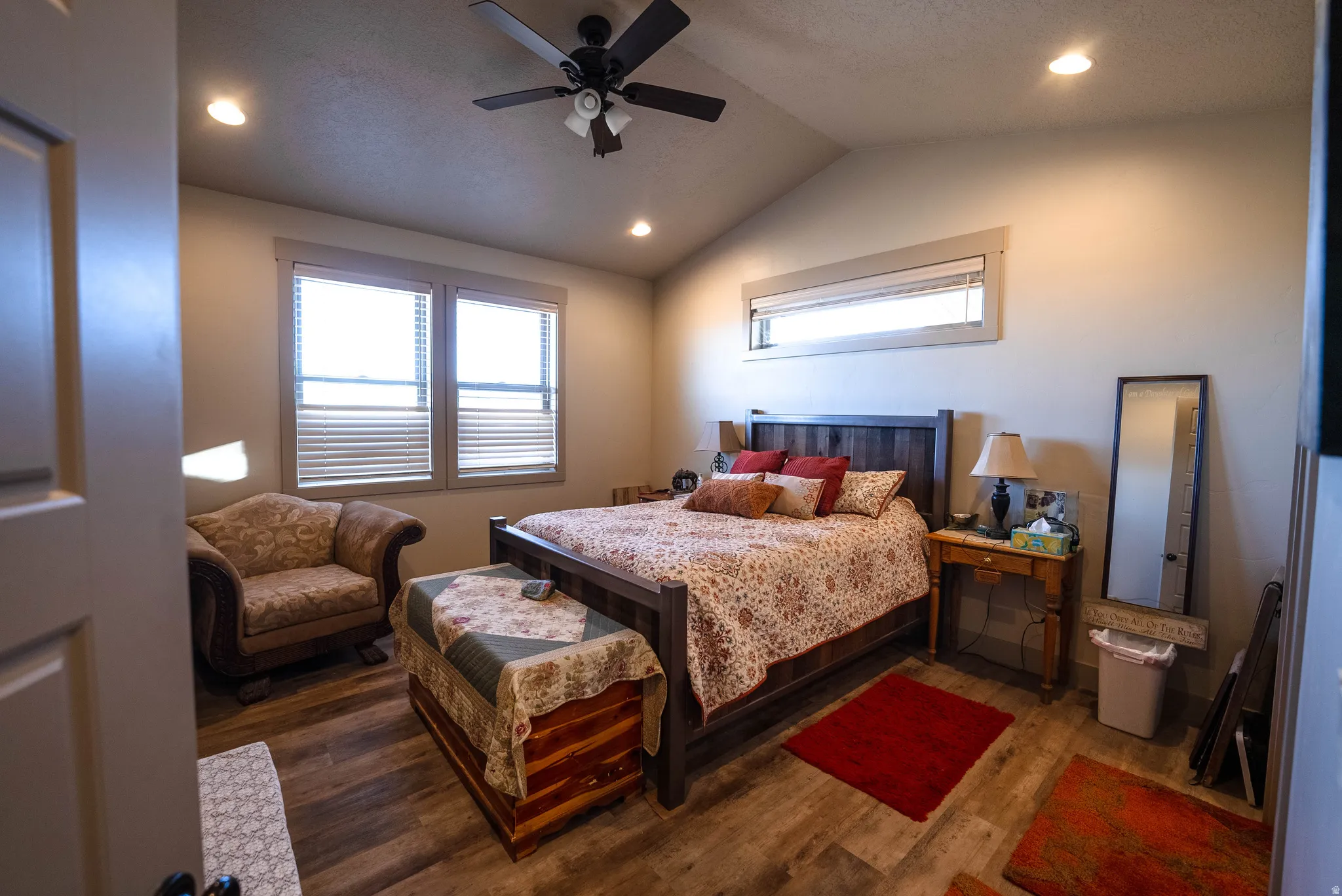 Bedroom with wood finished floors, lofted ceiling, ceiling fan, and recessed lighting