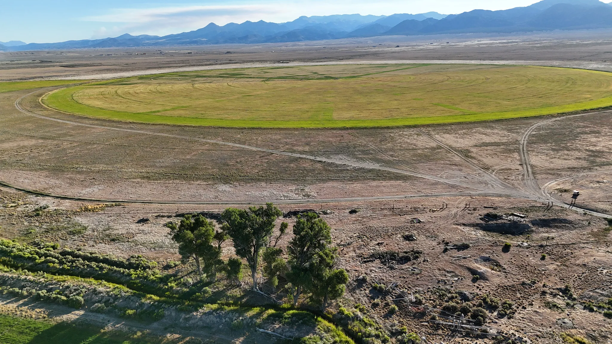 Aerial overview of property's location featuring a mountain backdrop and rural landscape
