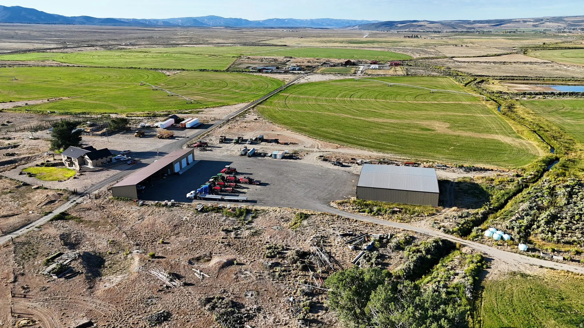 Aerial view of property's location featuring a mountain backdrop and rural landscape