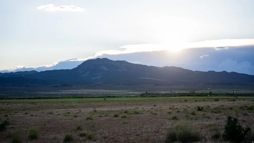 Expansive foreground with natural vegetation and distant mountain range