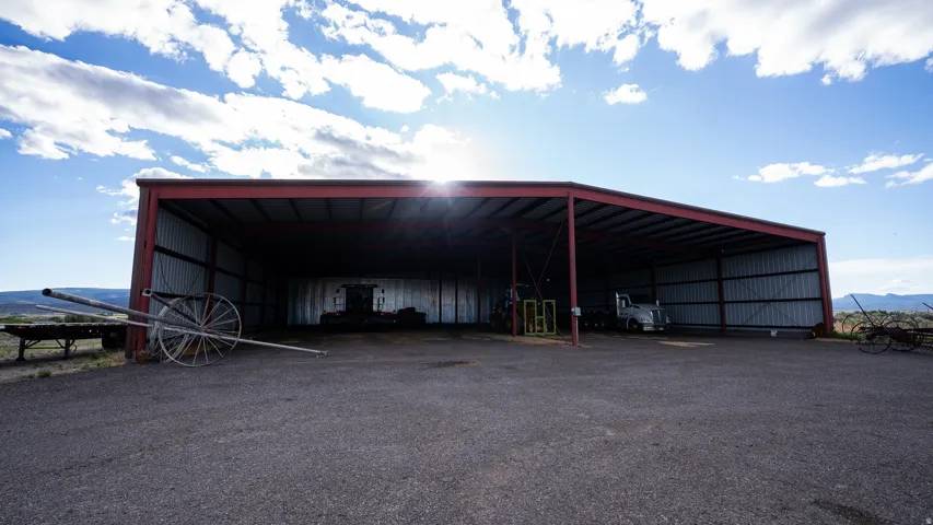 Expansive metal-framed structure with a red-painted framework and corrugated metal siding