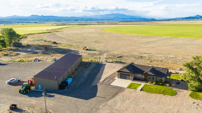 Modern ranch-style residence featuring an attached garage, a manicured lawn, and a concrete driveway