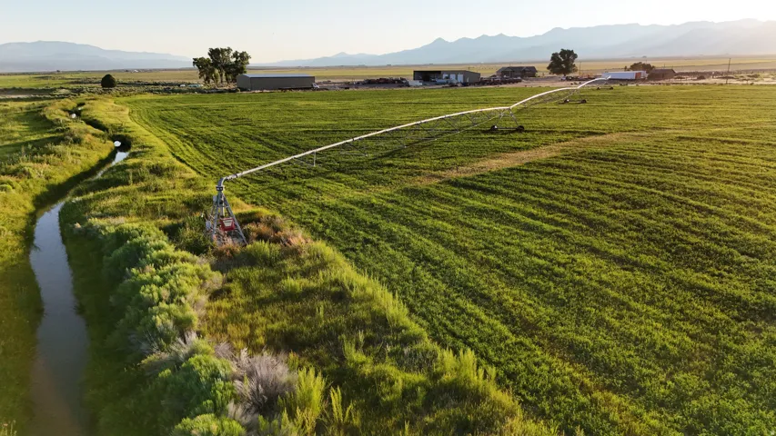 Expansive agricultural property featuring cultivated fields and a visible irrigation system
