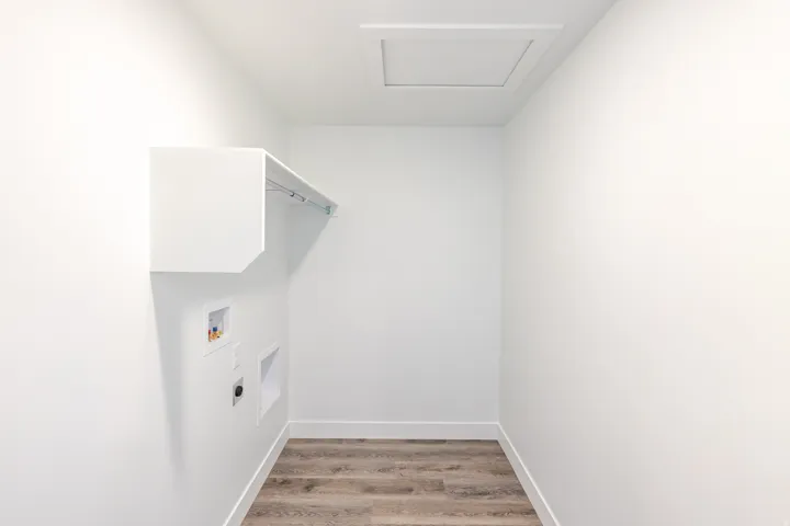 Laundry room featuring light wood-type flooring, hookup for a washing machine, and electric dryer hookup