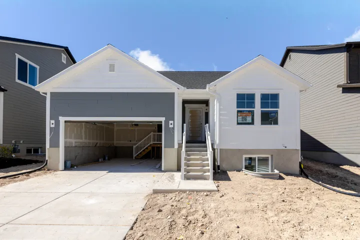 Ranch-style house with a garage and concrete driveway