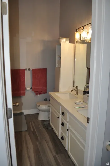 Bathroom with double vanity and dark wood finished floors