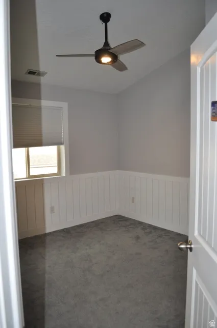 Unfurnished room with a ceiling fan and carpet floors