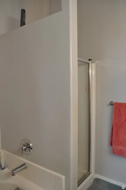 Full bath featuring a shower stall and a bath