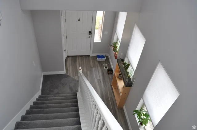 Stairs with baseboards and wood finished floors