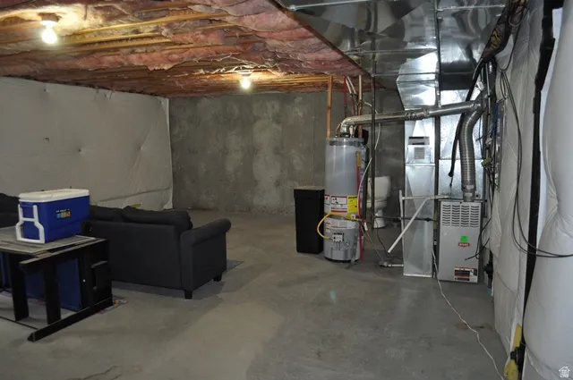 Unfinished basement with gas water heater and heating unit