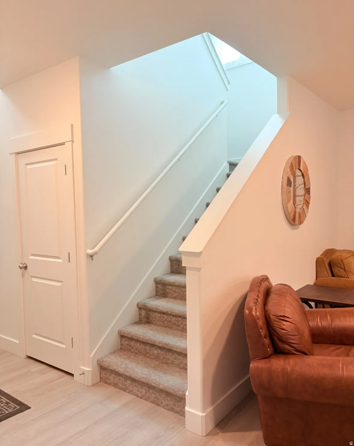 Stairway featuring wood finished floors and baseboards